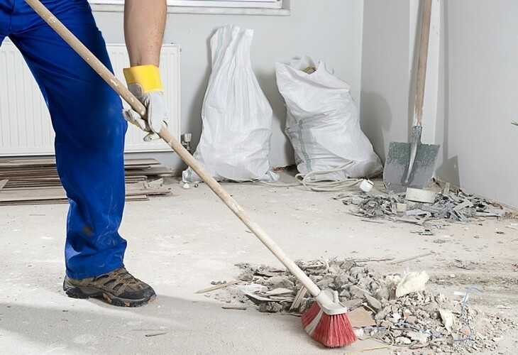 A worker cleaning a construction site.